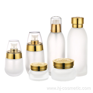 wholesales High-grade golden carved ABS cap transparent glass cosmetic bottles/jars with good price